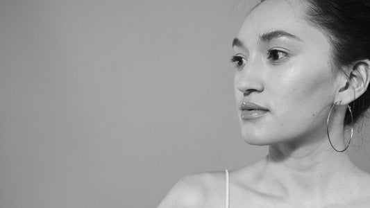 Cover — a real person wearing the three styles across three small side-by-side shots (studs, hoops, climbers), warm natu