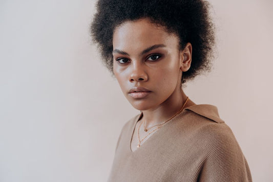 Gold vermeil hoops worn by a woman in natural light — Juno & Fern Journey Flow Hoops