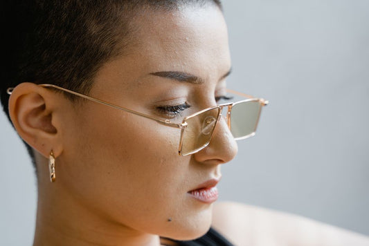 Gold ear climber earring tracing up a woman's ear lobe