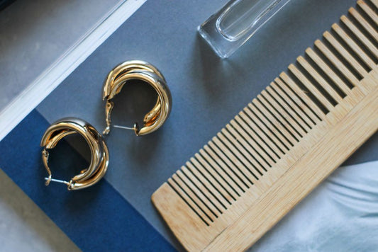 Minimal jewelry flat lay on warm background showing different jewelry styles