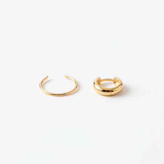 Two gold earrings side by side: small hoop with gap versus huggie sitting flush on the lobe